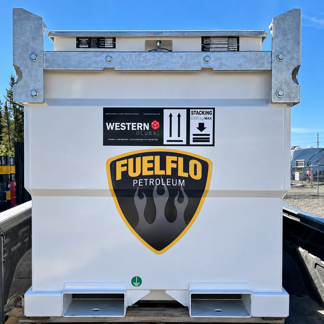 White Western Global tank carrying a Fuel Flo shield decal, loaded in a pickup truck bed