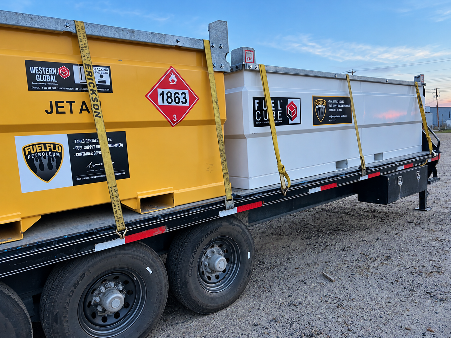 Fuel Flo branded Western Global JET A tank and white FuelCube tank secured on a flatbed trailer
